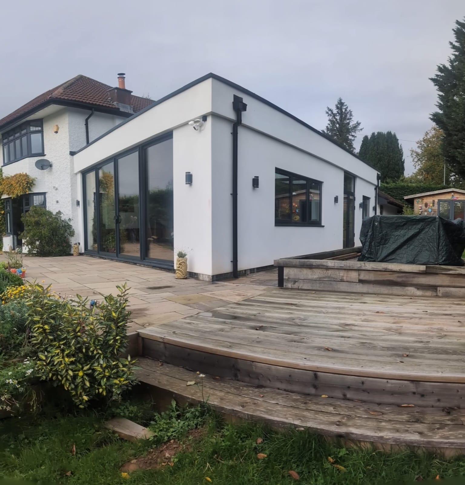 Modern white kitchen extension with anthracite aluminium bi-fold doors fitted by Essential Glazing