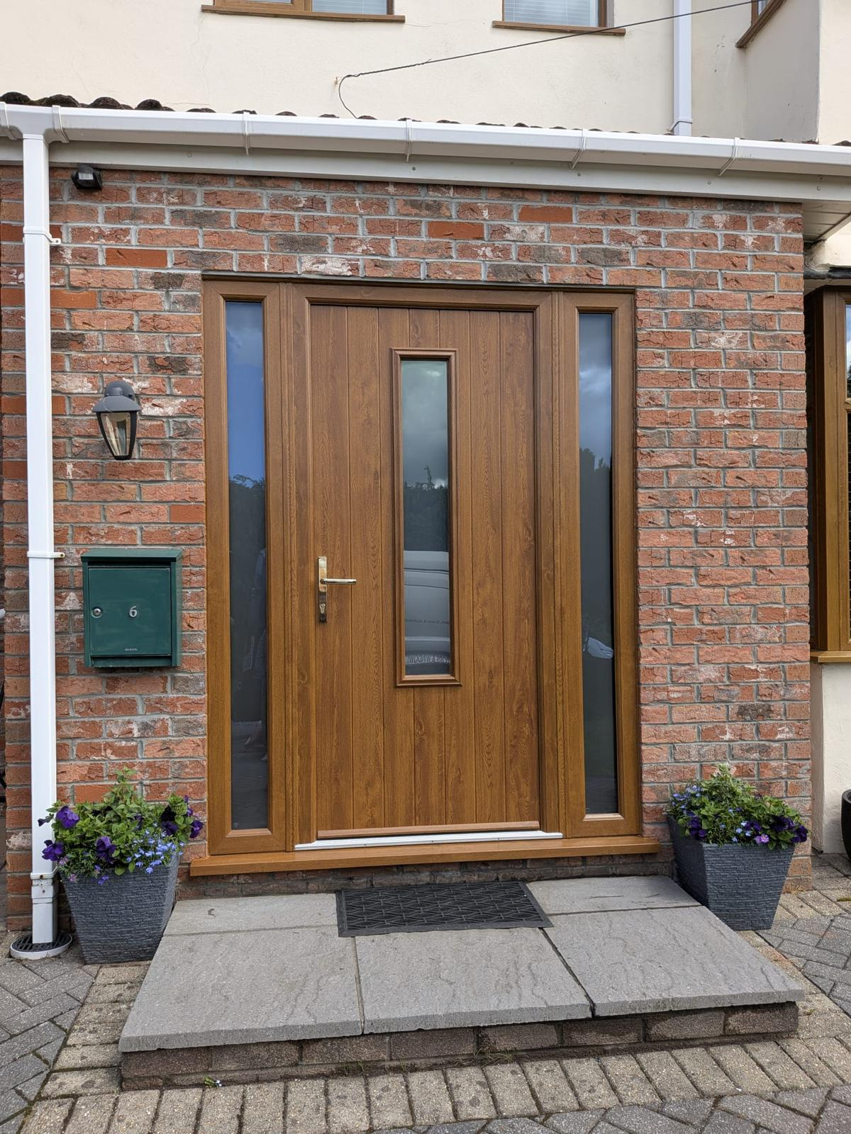 Oak-effect composite door with colour-matched frame and glazed side panels